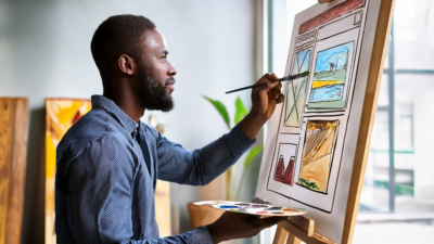 person painting a watercolor picture of a webpage on a canvas